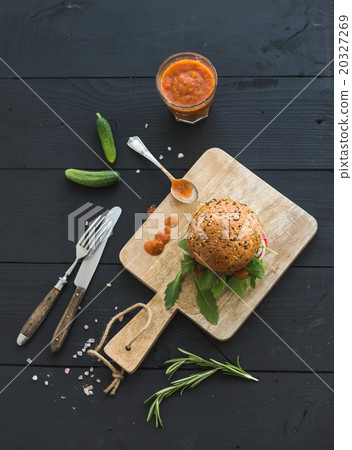 Fresh homemade burger on dark serving board with 20327269