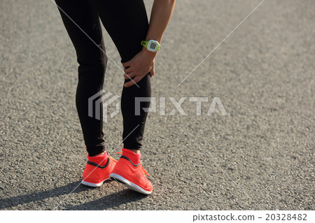 woman runner hold her injured leg on road.. woman runner hold her injured leg on road.. 20328482