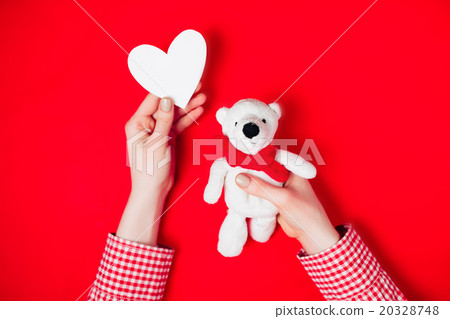 woman holding white bear on red woman holding white bear on red 20328748