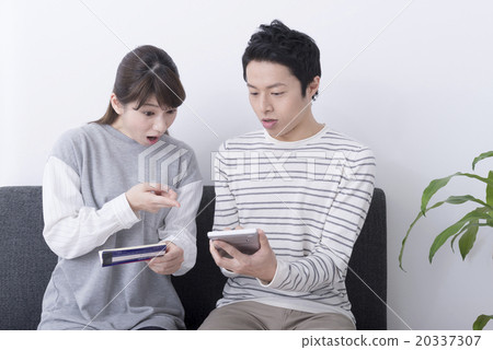 Couple confirming passbook Couple confirming passbook 20337307