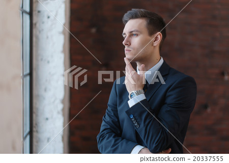 Portrait of a businessman looking at the window. Portrait of a businessman looking at the window. 20337555