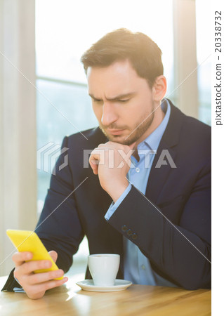 Handsome man looking concerned staring at his 20338732