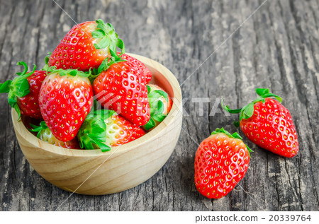 Red Strawberries in brown wooden bowl 20339764