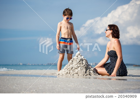 Young mother and her little son building sand 20340909