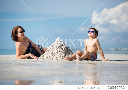 Young mother and her little son building sand 20340912