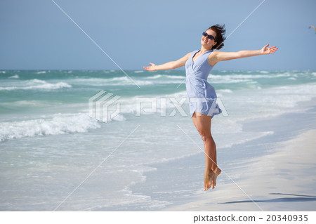 Beautiful woman jumping on Florida Beach 20340935