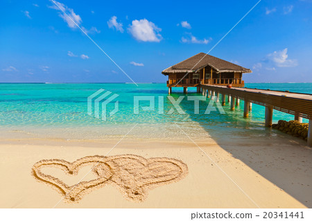 Drawing connected hearts on beach Drawing connected hearts on beach 20341441