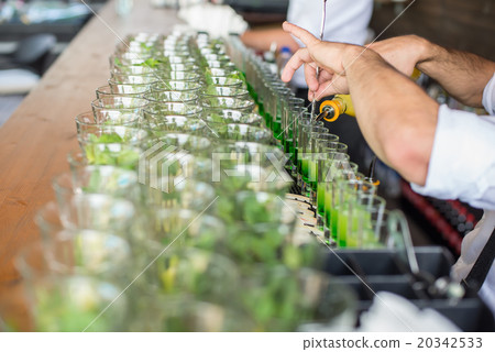 barman pouring an alcoholic cocktail served in bar barman pouring an alcoholic cocktail served in bar 20342533