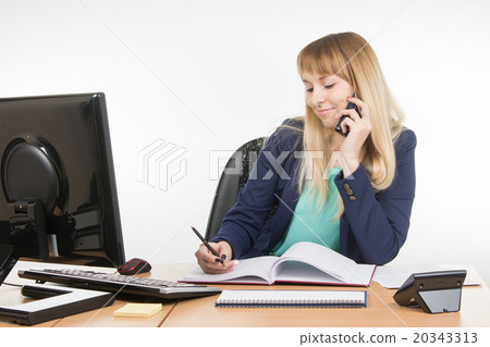 Business woman talking on the phone and writes in the book office Business woman talking on the phone and writes in the book office 20343313