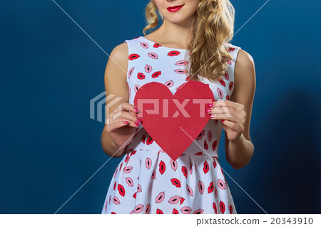 pretty blond woman holding red paper heart pretty blond woman holding red paper heart 20343910