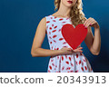 pretty blond woman holding red paper heart  20343913