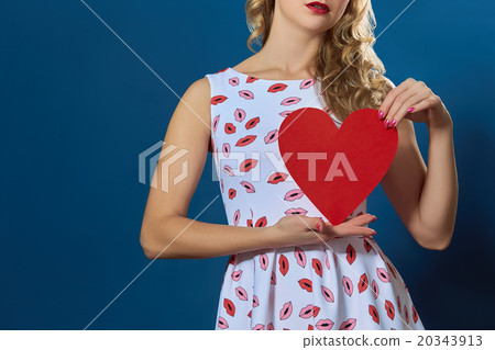 pretty blond woman holding red paper heart pretty blond woman holding red paper heart 20343913