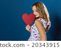 Profile pretty blond girl holding red paper heart  20343915