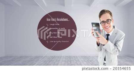 Composite image of geeky smiling businessman showing calculator 20354655