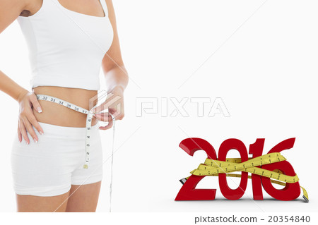 Composite image of midsection of woman measuring waist 20354840