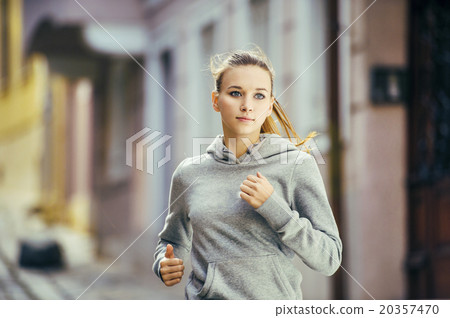 Young woman running in city center Young woman running in city center 20357470