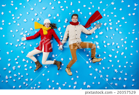 Young couple in winter studio having fun 20357529