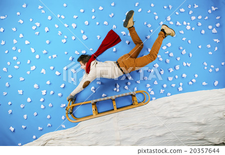 Young man on sled having fun Young man on sled having fun 20357644