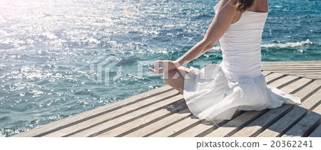 Woman meditating at the sea Woman meditating at the sea 20362241