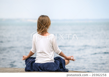 Woman meditating at the sea 20362258