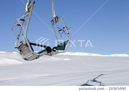 Chair-lift in ski resort at sun day after snowfall 20365690