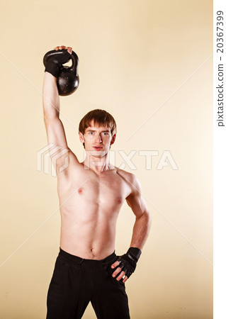 Man lifts a weight in one hand. 20367399