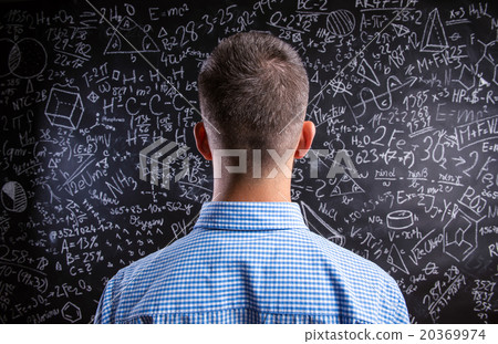 Back view of teacher against big blackboard with Back view of teacher against big blackboard with 20369974