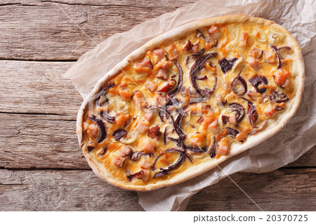 Tarte flambee on a paper. Horizontal top view Tarte flambee on a paper. Horizontal top view 20370725