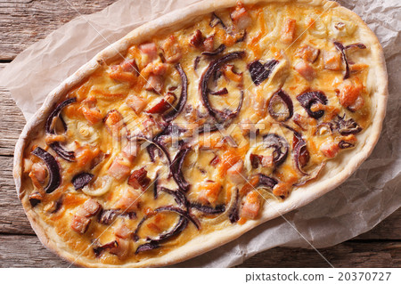 Tarte flambee close-up on a paper top view 20370727