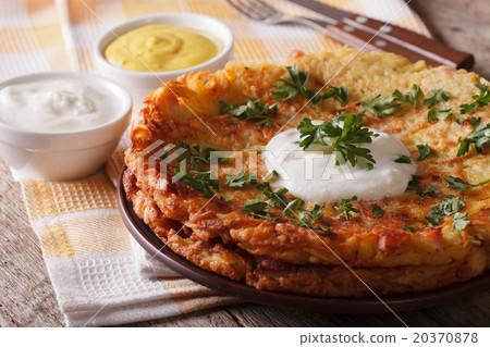 Rosti with sauce and parsley closeup on a plate 20370878