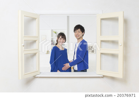 Pregnant couple over the window 20376971
