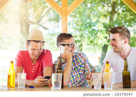 Friends drinking and using smartphone 20379547