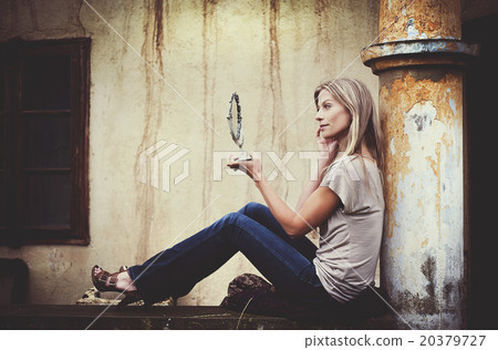Woman by old house 20379727