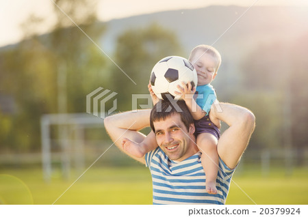 Father and son playing football 20379924