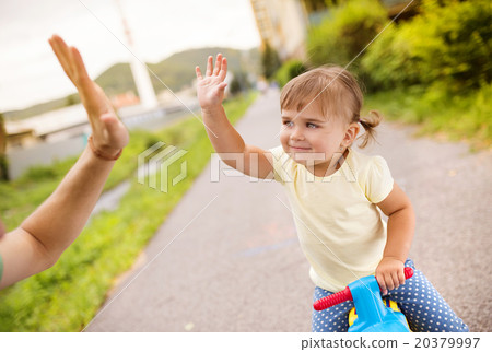 Father and daughter on motorbike in park Father and daughter on motorbike in park 20379997