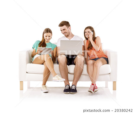 Young people on sofa with laptop 20380242