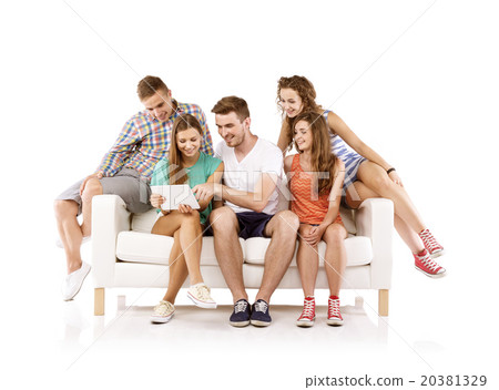Group of young people on sofa with tablet 20381329