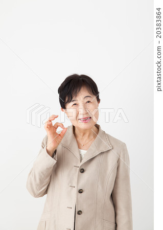 Senior woman OK sign pose 20383864