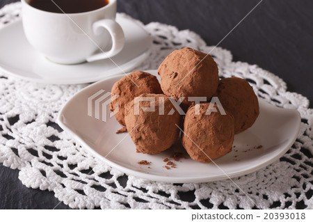 Chocolate truffles on a plate and coffee close-up Chocolate truffles on a plate and coffee close-up 20393018