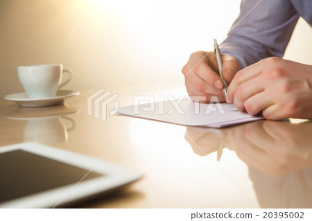 The male hands with a pen and the cup The male hands with a pen and the cup 20395002