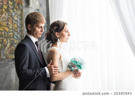 beautiful bride and groom near the window. 20395943