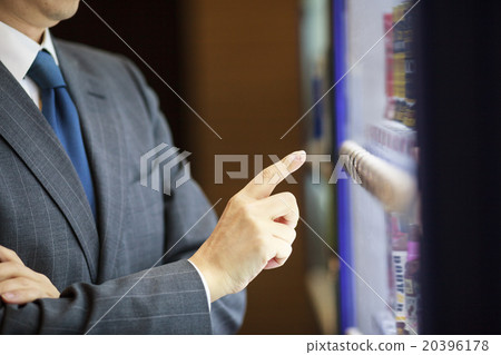 Businessman buying juice with vending machine Businessman buying juice with vending machine 20396178