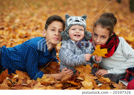boys and girl in autumn park 20397326