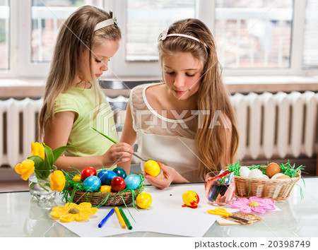 Children paint Easter eggs at home. Children paint Easter eggs at home. 20398749