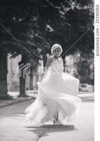 Young beautiful bride posing outdoors Young beautiful bride posing outdoors 20398868