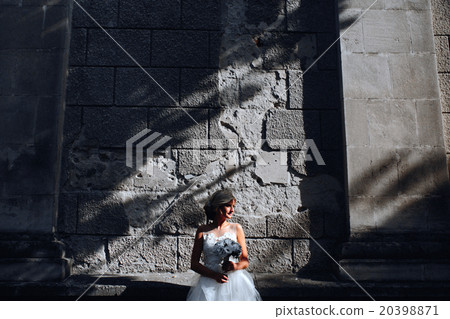 bride posing on stone wall background bride posing on stone wall background 20398871
