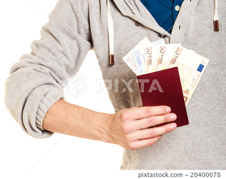 Tourist holding passport full of money. Tourist holding passport full of money. 20400078