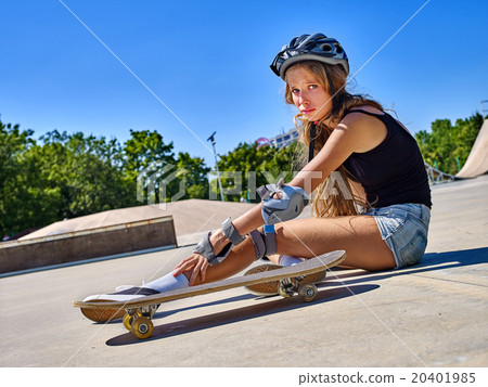Sport girl with injury near her skateboard outdoor 20401985