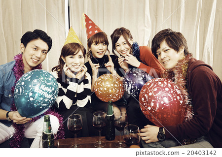 Men and women enjoying home parties Men and women enjoying home parties 20403142