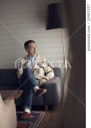 A man sitting by the window 20403357
